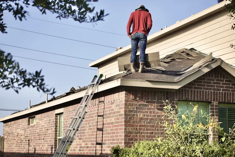 Professional roofer working on a residential roof in Carver Beach